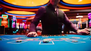 Baccarat table with professional dealer and card shoe at tiktak toto
